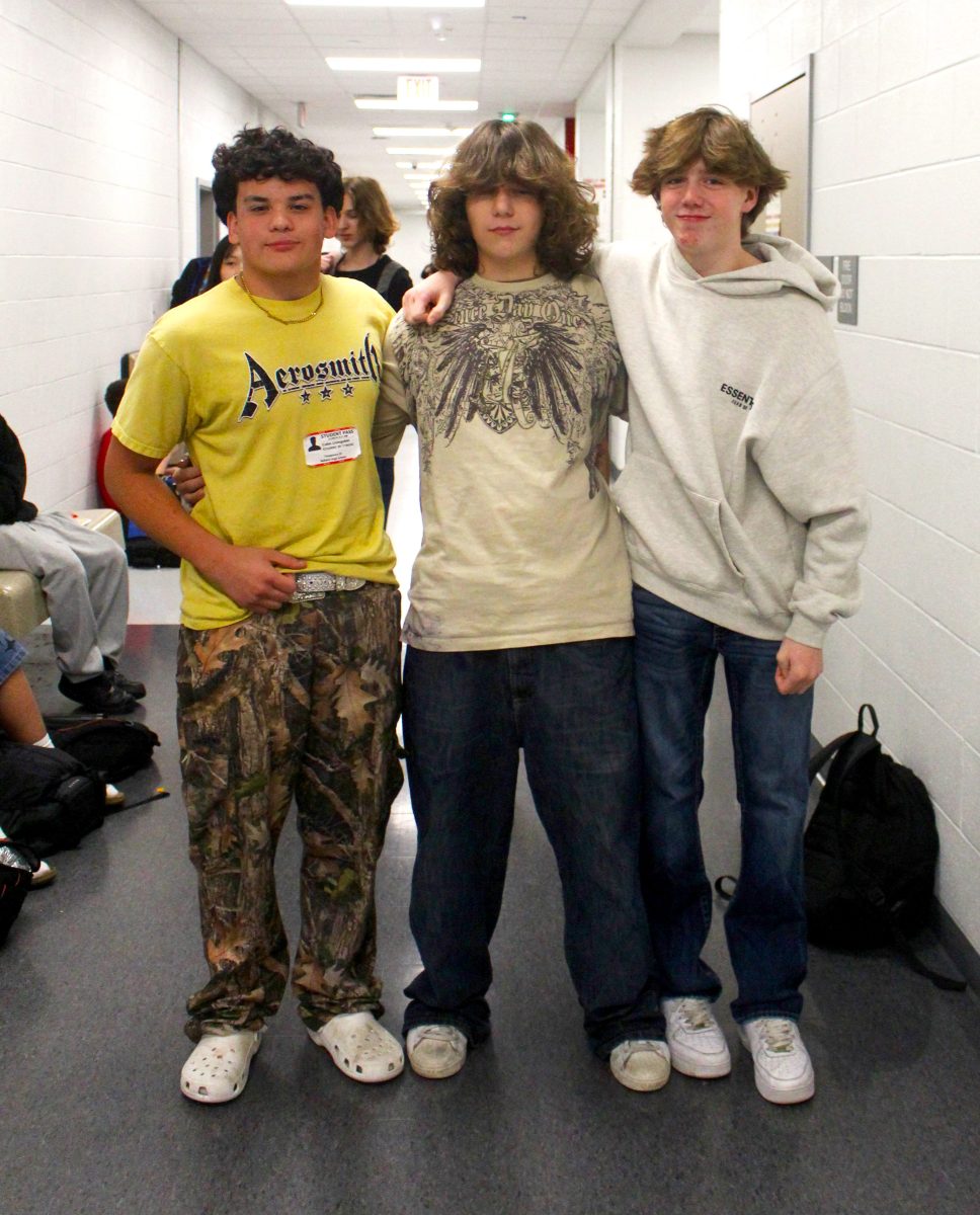 Millward poses with his close friends Livingston (left) and Caplan (right). They are all wearing thrifted clothes.