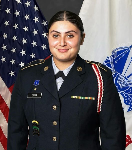 In this picture, Luna is seen wearing her red-white cord, ribbons, and badges. The red-white cord symbolizes her place on staff, and her ribbons are earned through competitions.