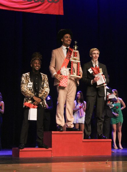 Senior and Mr. Bellaire winner Joshua Percy beams on the podium next to second- and third-place winners seniors Flynn Collins and Jermaine Hayden. All three of the top winners are members of Red Bird Productions.