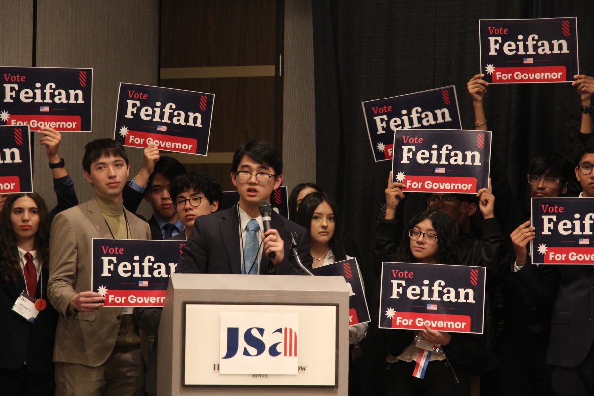 Junior Feifan Liu delivers his candidacy speech as his supporters hold campaign signs. His FART platform focused on fundraising, activism, regionalism and transparency.