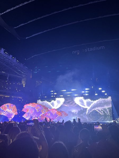 Fans in attendance of the Houston Taylor Swift Eras Tour are pictured filming and videoing the artist. The presence of phones and videography has increased greatly and impeded enjoyment of live events.