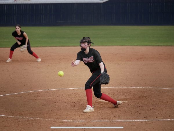 Turney pitches the ball during a softball game. Turney said that softball has helped her get closer with friends and coaches and build new relationships.