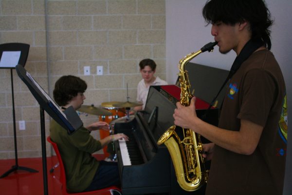 Members of the rhapsody club perform during Cardinal Hour as background music for students. From left to right, officers Koen Plank, Kai Plank, and Matthew Guzman.