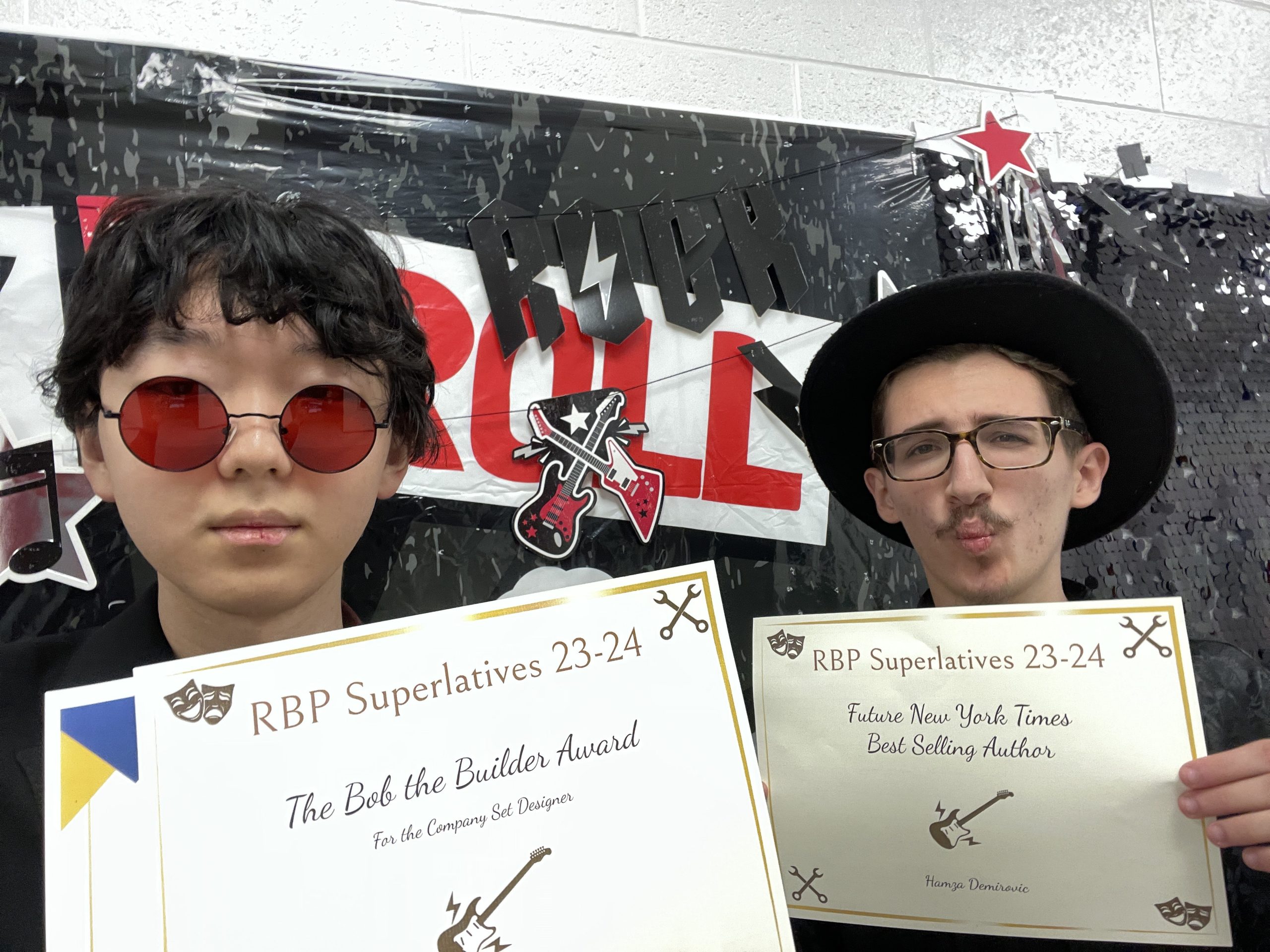 Seniors Justin Lee and Hamza Demirovic hold up the superlatives they won at the 2024 Red Bird Productions banquet. Justin encouraged Hamza to take Tech Theater 1 with him at the end of their freshman year, and they have spent the last two years together in the varsity tech theater class.