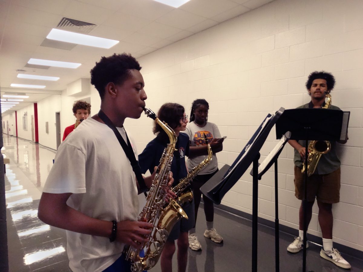 Darren Romer practices the saxophone during sectionals. Band members were told to use sheet music for the first three times before playing from memory.