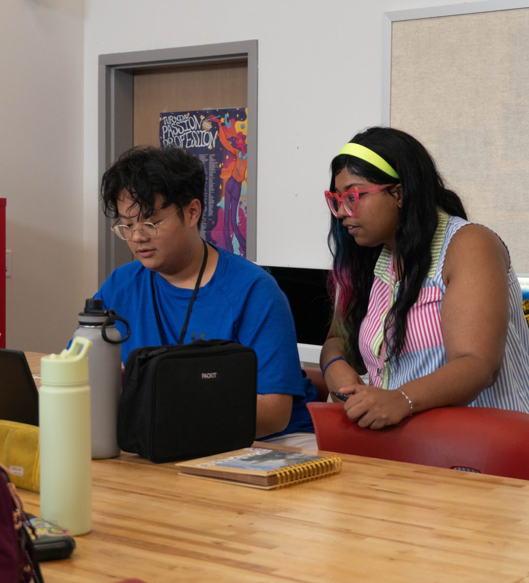 Looking at sophomore Grayson Ho's work, AP 2-D Art and Design and photography teacher Courtney Skinner gives pointers to help Ho improve his work during a photography class. "I do kind of feel myself getting better at photography," Ho said. "I feel more creative."