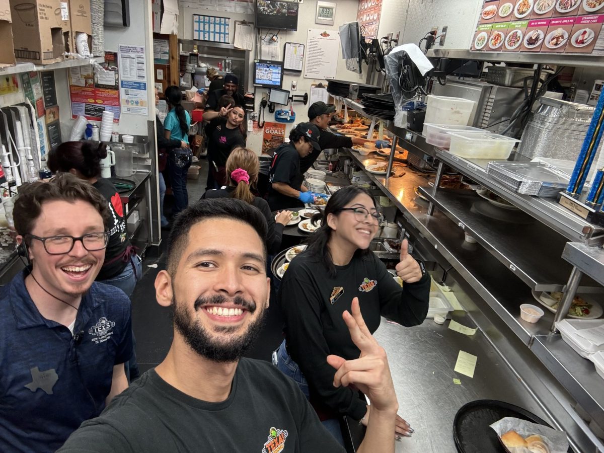 Miguel Gonzalez poses with his coworkers at the Texas Roadhouse. He worked there over the summer and school year as a server.