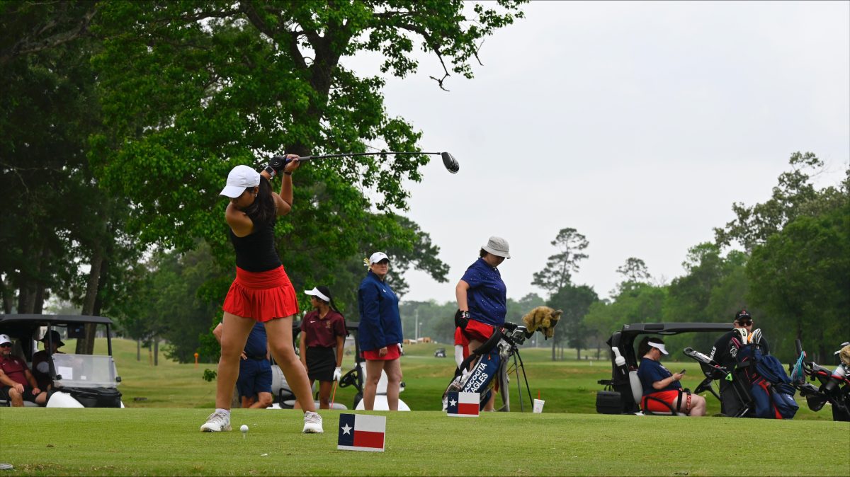 Genesis Torres swings to drive the golf ball in the Regionals tournament. She focuses on her swing, and aims to avoid the lake near the hole.