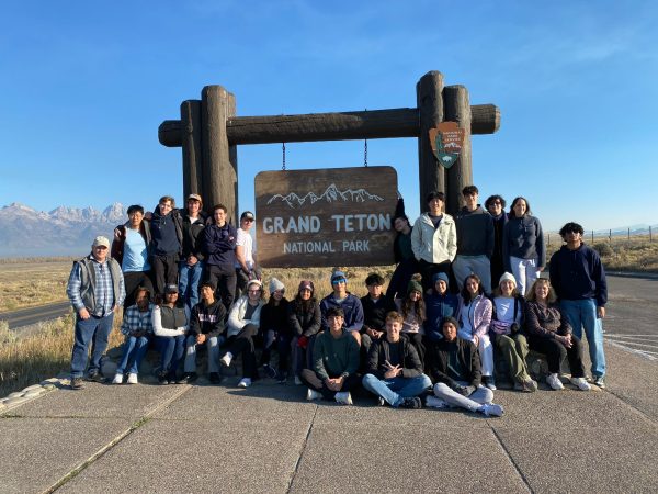 The entire group takes a picture in front of the Grand Teton National Park sign. Grand Teton is only about an hour south of Yellowstone National Park.