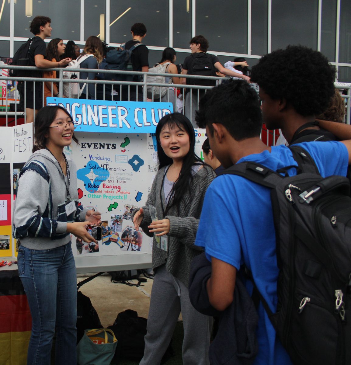 Juniors Cathryn Vera and Joy Xia showcase Engineering Club's trifold to students. They were recruiting members during Club Jamboree.