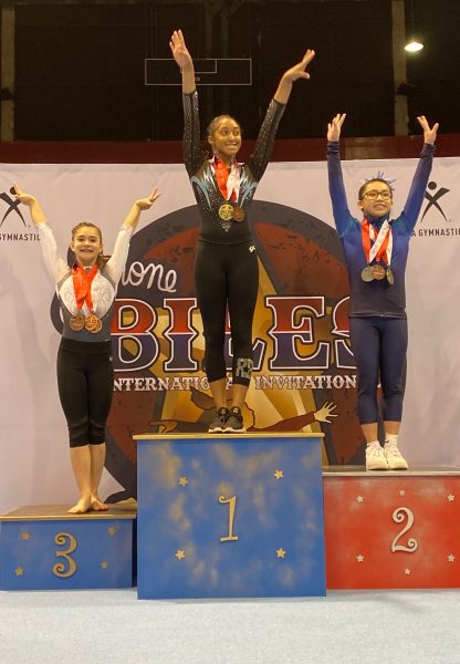 Gabriella Alves-Gillete stands on the podium at the Simone Biles Invitational. She placed third overall.