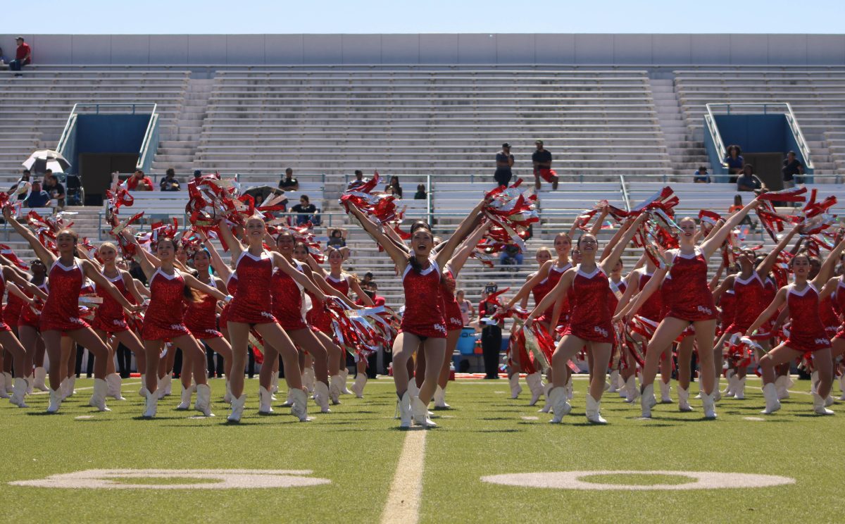 The varsity and junior varsity Belles end the halftime show dance number 'Walking on Sunshine' with a final pose. This number is the only time throughout football season that the varsity and all of the JV Belles would perform together.