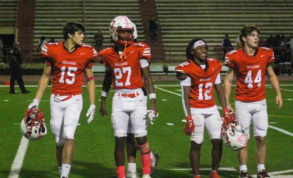 John Corder, Keaton Davis, Kavalli Stroman, and Michael Caspary walk off the field following Bellaire's win. They are joined as part of the post-game alma mater.