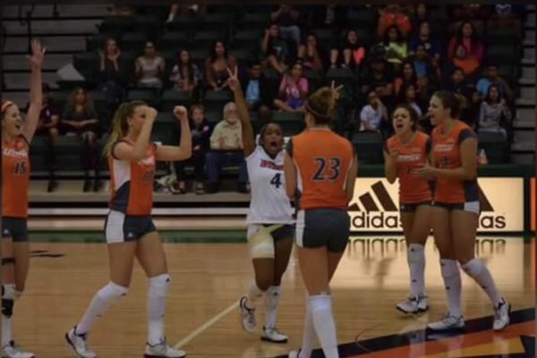 Brianna Jones (#4) celebrates after her team wins the point. Jones played libero at the University of Texas Rio Grande.