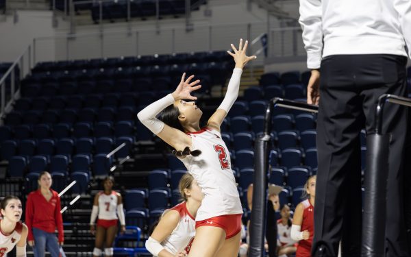 Sophomore and right side hitter Olivia Wang prepares to hit a ball during the varsity match against Lamar. Cardinals won the first set, lost the second two, and came back to win the final two sets, securing a victory.