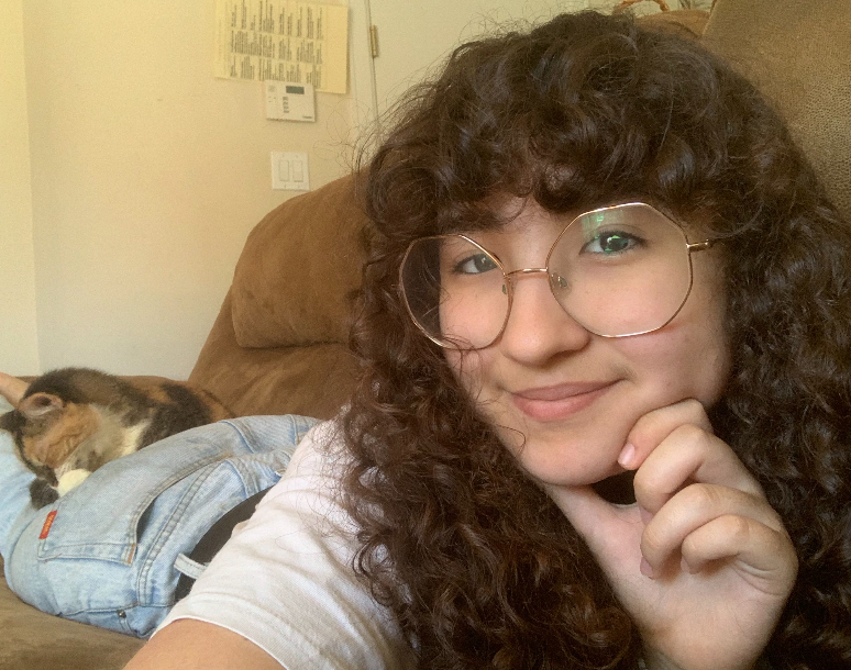 Rocha poses with one of her other foster cats, Charlotte. After her father, who supposedly hates cats, fell in love with this calico, they ended up making her a permanent appendage of their family.