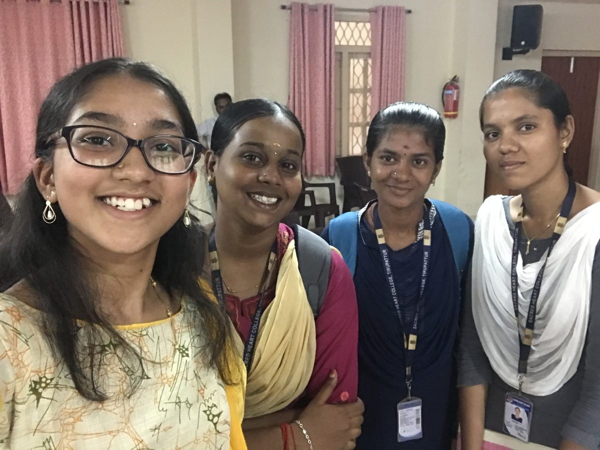 Junior Akshatha Perumal meets three of the trainees she taught during the summer in India. Perumal taught around 40 trainees English from June to August.