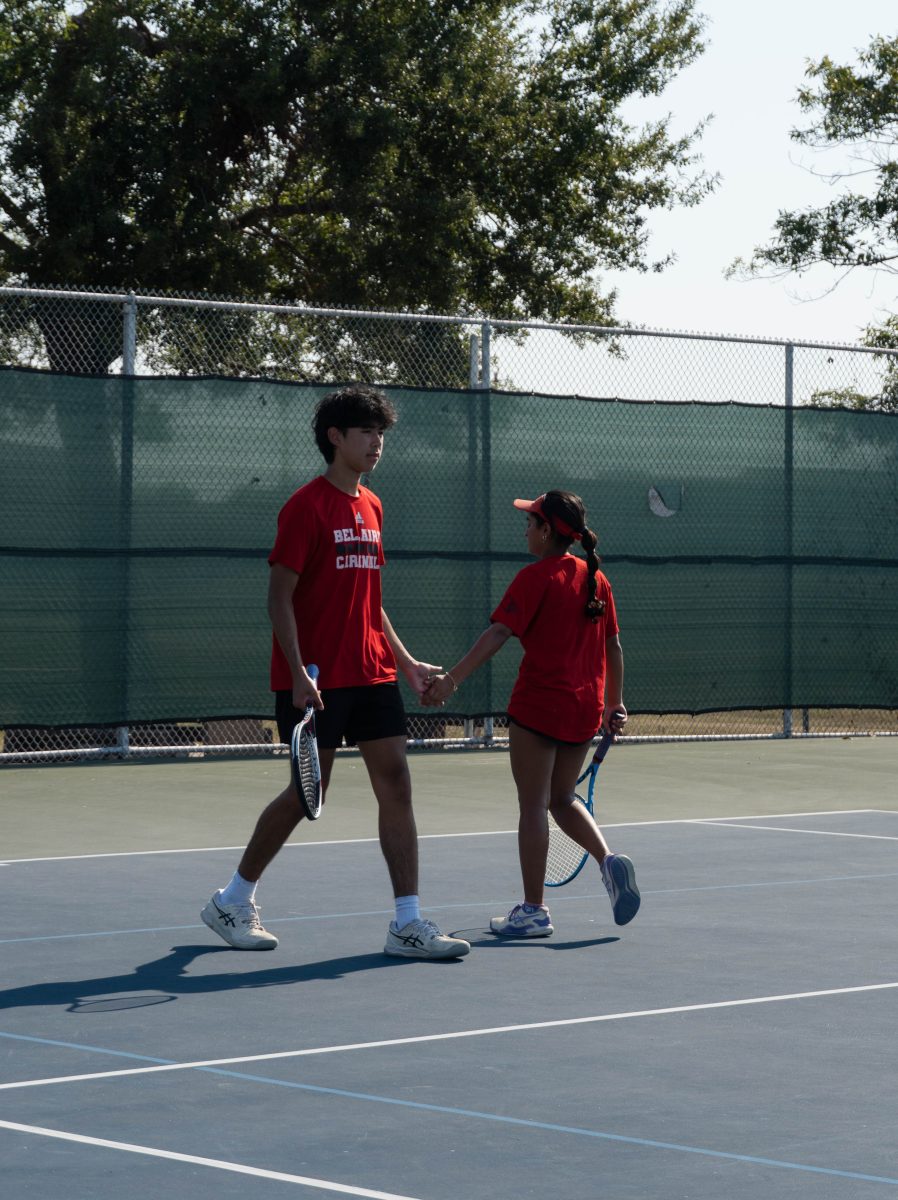 Seniors Alen Polatbekov and Saachi Gupta celebrate after winning the game point with a low-five. The pair played two sets before heading into a tiebreaker in the mixed doubles draw.