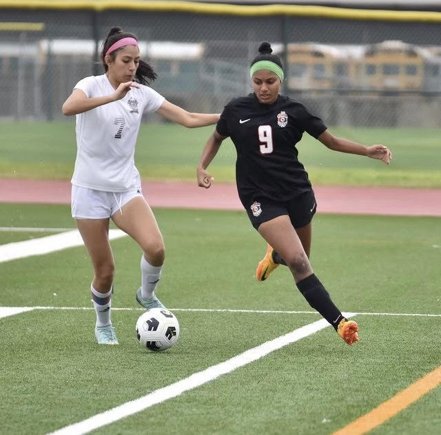 Senior and varsity girls soccer captain makes a split-second decision on the field. "[Moving up to varsity helped] my skills develop because I was playing at such a high level," Oomman said. "Some games, it was tough."