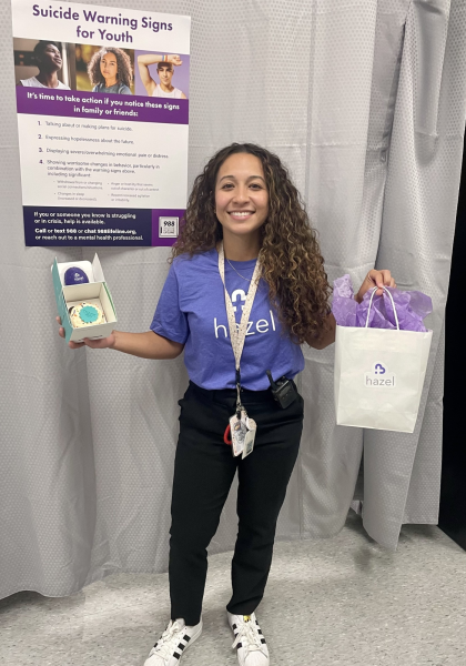 Social worker Stephanie Aguilar poses with a gift she received from Hazel Health. Aguilar was recognized as one of the top referrers for Hazel Health on Oct.16. 