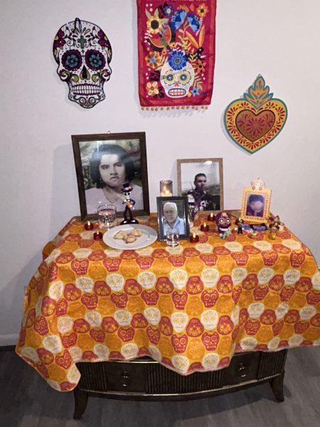 Senior Angela Chavez's ofrenda is decorated with candles, conchas and pictures of her deceased relatives, including her forever 6-year-old cousin.