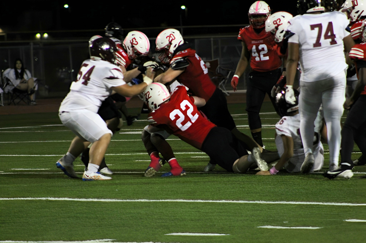 Senior defensive tackle Martin Van den bossche, senior linebacker Chris Wilson, and sophomore linebacker Sullivan Mulcahy corner the quarterback. They work together to sack the quarterback.