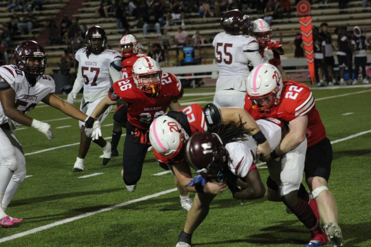 Senior linebacker Chris Wilson and Sophomore linebacker Sullivan Mulcahy grab the quarterback. They successfully stop the opposing quarterback from gaining further yards.