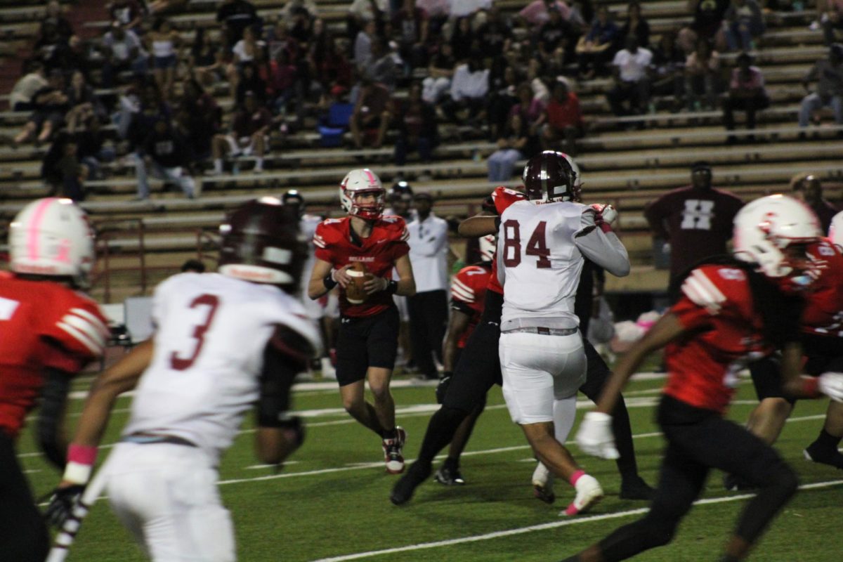 Junior Quarterback Will Hazen receives the ball from a snap. He is looking for an open player to throw the ball to.