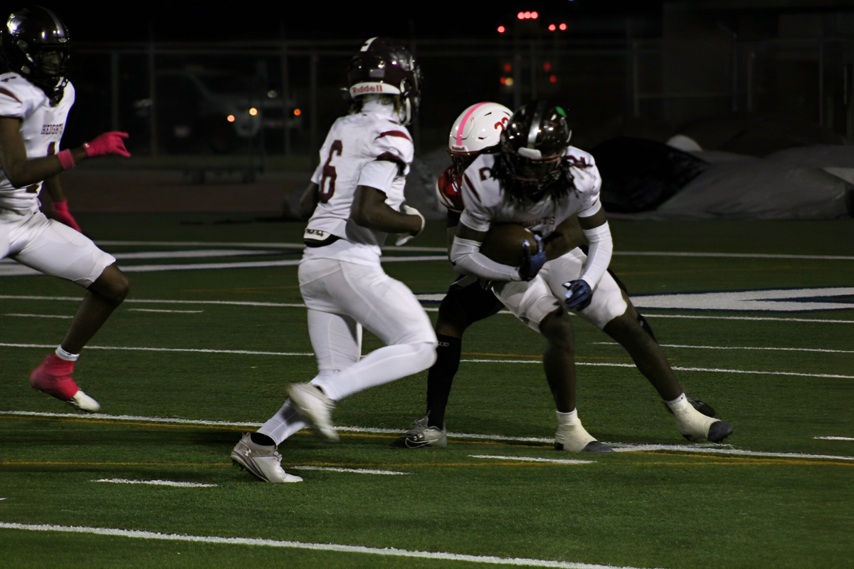 Junior defensive back Bishop Jones finds an opening towards the opposition’s quarterback. He manages to wrap his hands around the quarterback taking the quarterback down.