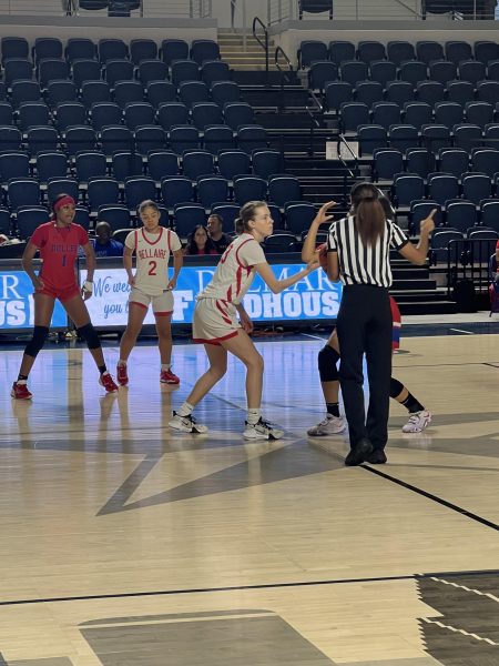 Junior Maisie Moncrief gets ready to do the jump ball. The Cardinals finished the 2023-2024 season with a 17-12 overall record.