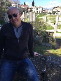 AP World History teacher Justin Cothran sits at an ancient forum in Athens, Greece.