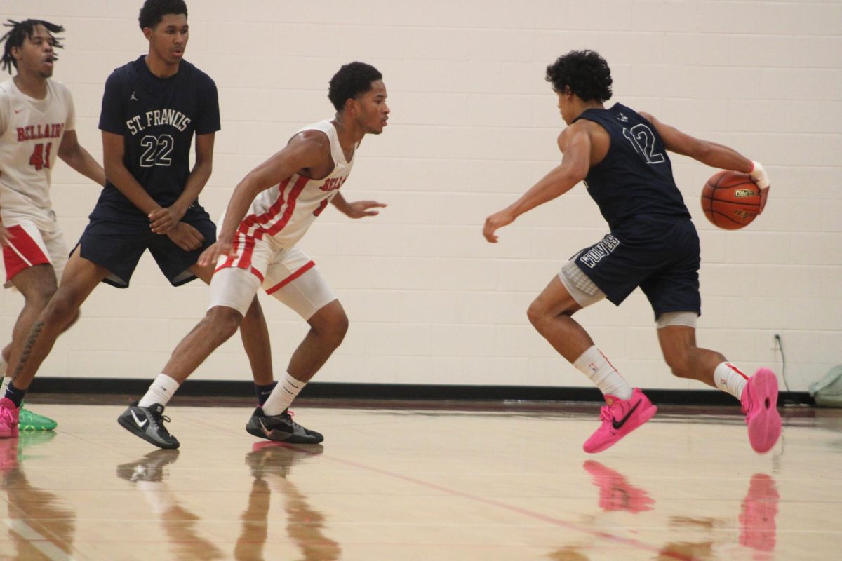 Senior point guard Kohlman Dutton tracks his player. He stops the player from rushing into the paint and forces a pass away.