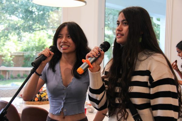 Kamea Ta, vice president of Karaoke Club, and Josephine Eltzschig, president, sing together at the Karaoke Club party. Eltzschig is the founder of Karaoke Club.