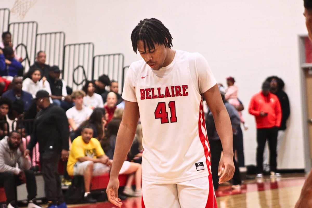 Senior power forward Anthony Andrews looks down as St.Francis scores a two-pointer to seal the game. He knows his team will likely lose and thinks of any way to equalize the score.