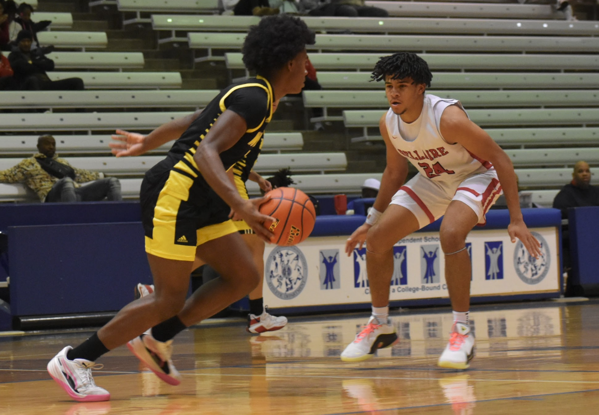 Senior Jaren Brown closely follows his opponent during the second quarter. Brown scored six total points with three 2-point field goals.