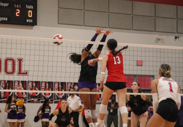 Freshman Grace Jackson hits the ball outside the block. This helped the team gain momentum in the second set.