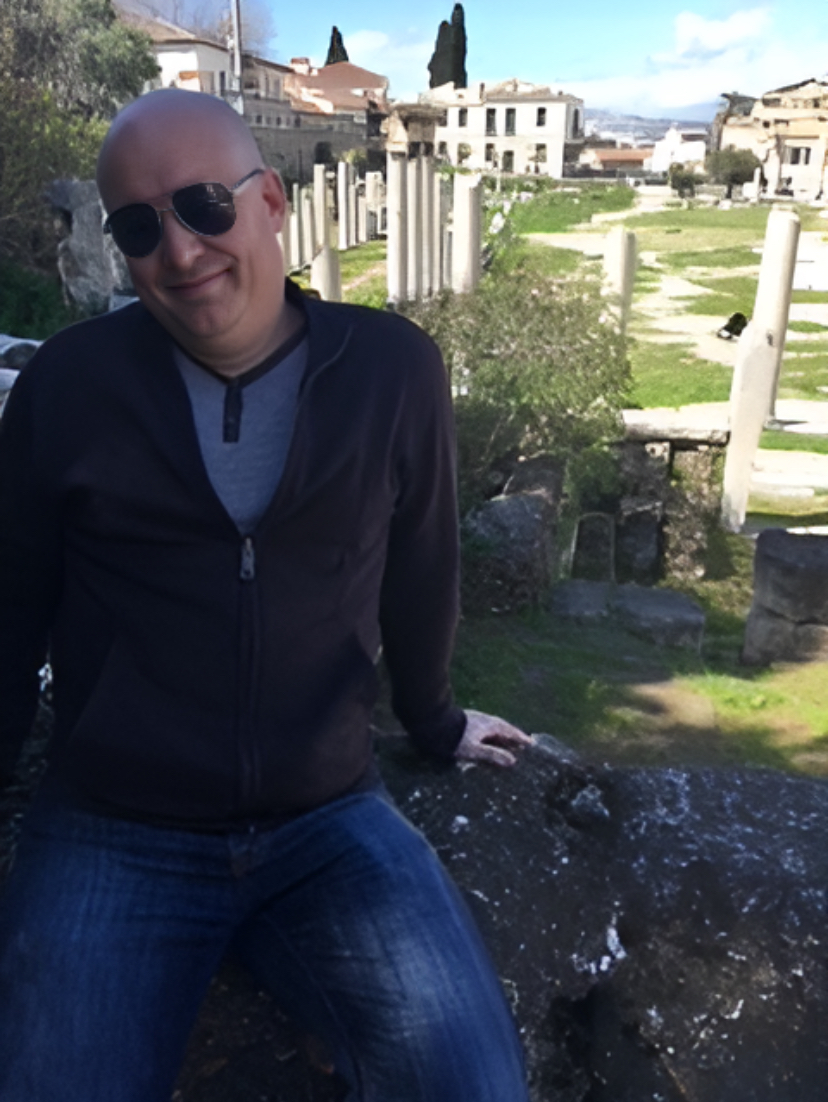 Justin Cothran poses at the ancient forum in Athens, Greece. Cothran enjoys traveling to the places he teaches about.