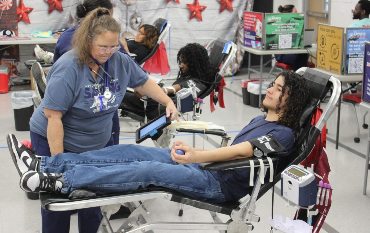 A healthcare worker prepares a student's cot before they donate blood. "For the most part, especially [at] bigger high schools, a lot of kids come in to donate because they want to get started on doing something good," healthcare worker Yuridia Rojas said. "And we do have a few people that, you know, do like to miss class."