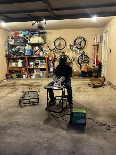 Iqbal welds together pieces of scrap metal to do tack welding, a method of temporarily fixing one metal piece by welding several small pieces of metal together. Welding is a skill Iqbal uses to build his go-kart.