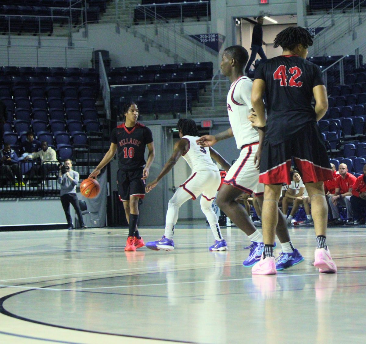 Sophomore point guard Jadarian Williams controls the ball while being guarded by a Lamar defender. He patiently waits for a que or an opening to pass the ball in order to surprise the opposing team.