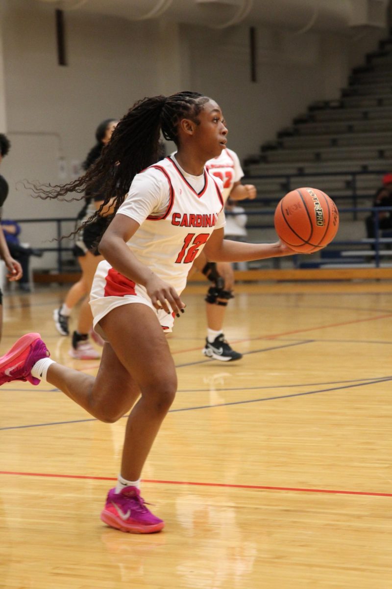 Junior Lauren Burns runs the ball down the court. The Cards beat Westside for the second time this season.