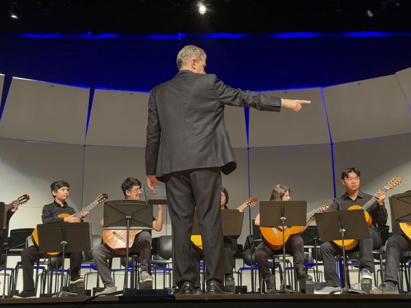 Director Edward Grigassy helps direct the Junior Varsity Ensemble. Grigassy is the All-City Guitar Festival Performance host this year.