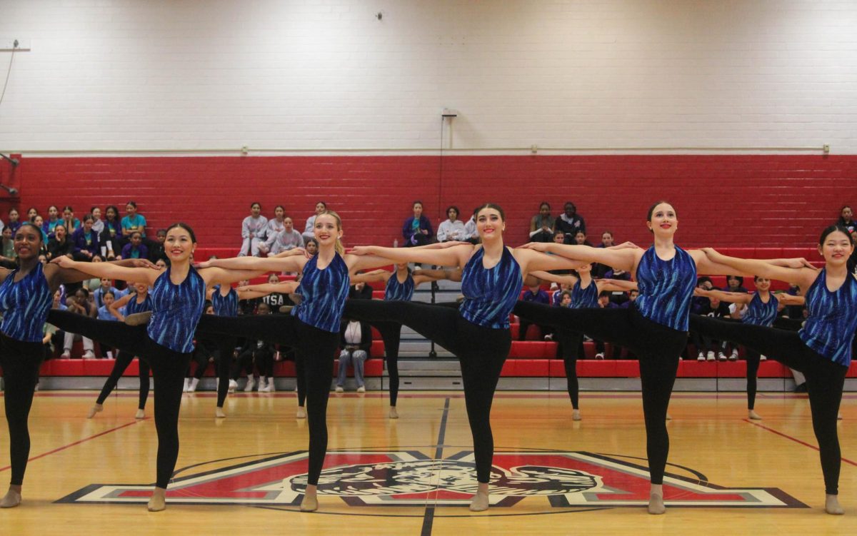 The junior varsity Belles stand in a kick-line during the junior varsity large kick ensemble. This was their first performance of the day.