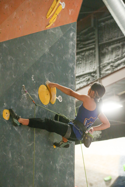 Ong resets and chalks up for her next move. She was participating in one of her first lead competitions at InSPIRE Cypress Rock Climbing.  