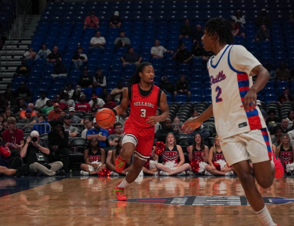 Senior Ejpyt Gibbs eyes possible openings from his teamates as he rushes towards Bellaire's side of the court. 