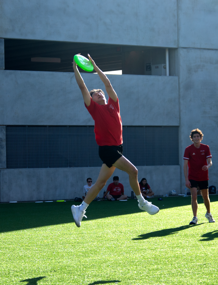 Senior Luke Wang leaps to secure the Frisbee near the end of match. Wang’s catch guaranteed a chance to secure a few final points before match ended.