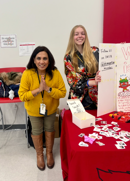 Hindi teacher Vibha Goswami and senior Autry Oran  pose at the Japanese booth. The booth was part of the Magnet Ambassador language spotlights that take place every month. 