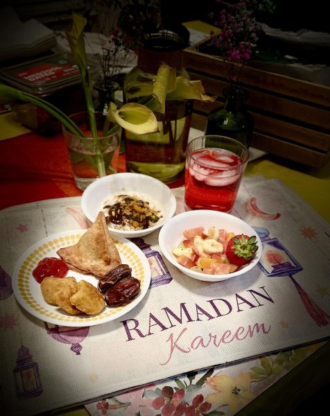 Dates, fruit salad, samosas and an array of flavorful spices fill bowls, creating the perfect snack to break a fast. Alongside, a refreshing glass of sweet red syrup mixed with water helps rehydrate after a long day of fasting.