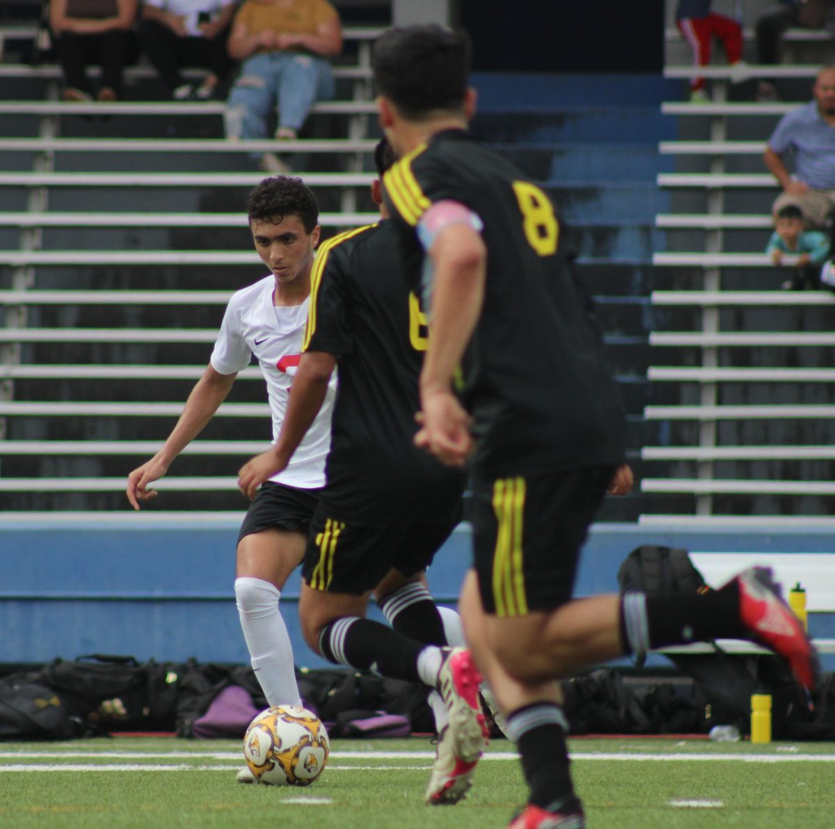 Junior Sayf Elkousy dribbles down the field avoiding the defender. Elkousy made the varsity soccer team sophomore year.