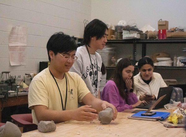 Junior David Fang molds clay into a plant pot. Members focused on creating functional pottery rather than sculptural pottery.